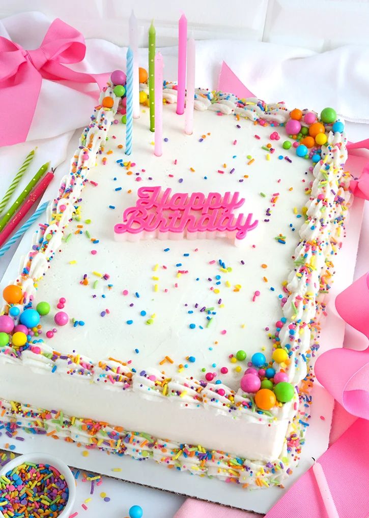 a birthday cake with white frosting and sprinkles