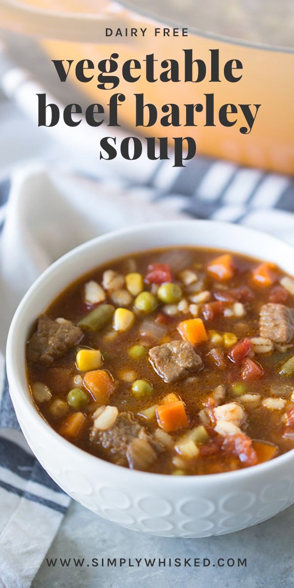 a bowl of vegetable beef barley soup on a blue and white table cloth with the title overlay