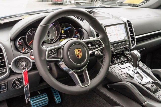 the interior of a sports car with steering wheel and dashboard