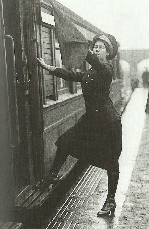 a woman leaning out the window of a train