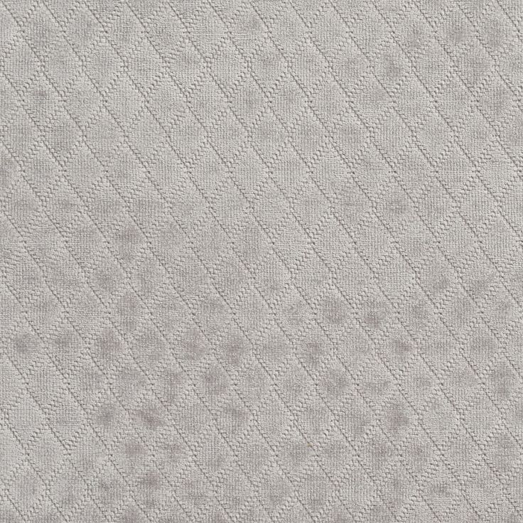 an upholstered fabric textured with small dots and lines in light grey color