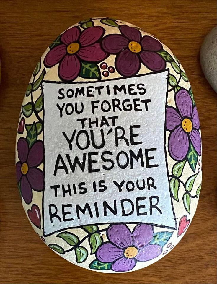 a painted rock with flowers on it that says sometimes you forget that you're awesome