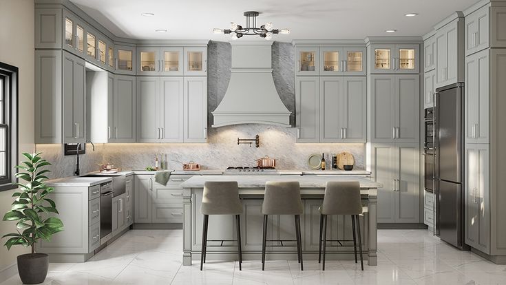 a large kitchen with gray cabinets and white counter tops