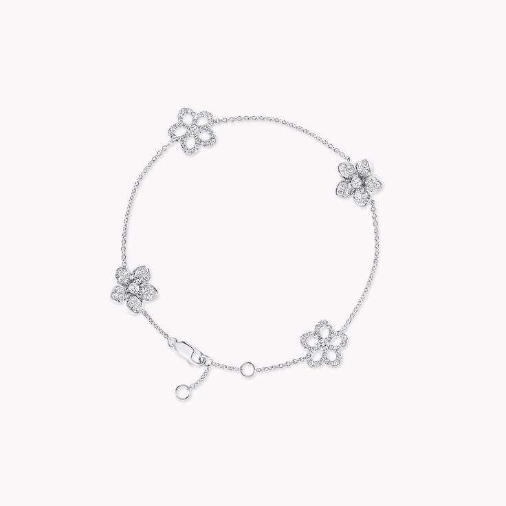 Four diamond flowers blossom upon our Wild Flower bracelet, unique down to every petal. Arranged with a wild touch, the two different styles of flower are exquisitely crafted to stand out, for an effect of both delicacy and strength. The Wild Flower collection is an invitation to escape into a garden that grows just for you. From trios and individual blooms to floral clusters and blossoms laid out in a row, each Wild Flower jewel is a statement of delicacy and of empowerment, designed to be worn Large Diamond Stud Earrings, Triple Diamond Ring, Large Diamond Rings, Rare Diamonds, Flower Diamond Ring, Pave Diamond Earrings, Diamond Bangles Bracelet, Platinum Jewelry, Heart Shaped Diamond