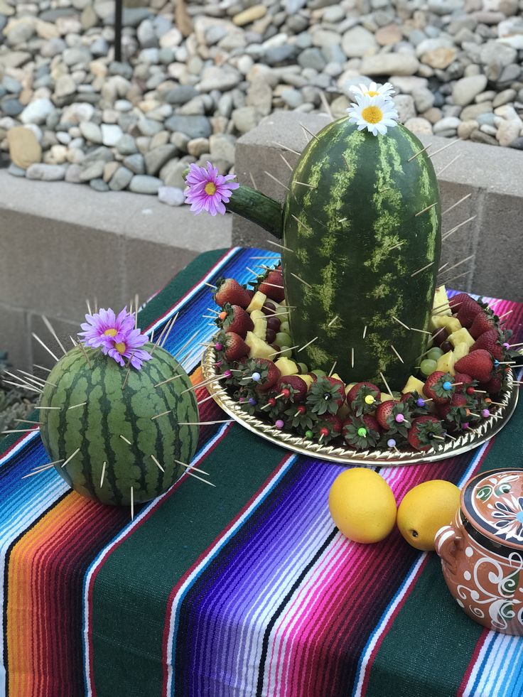 there is a watermelon and other fruit on the table