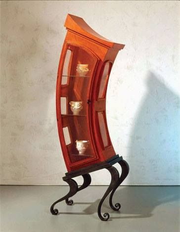 an orange glass display case with candles in it's bottom shelf and metal legs