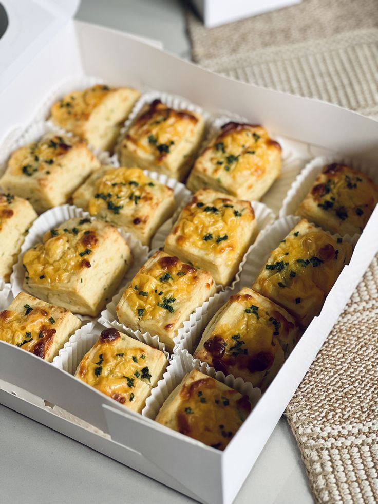 a box filled with lots of different types of food on top of a white table