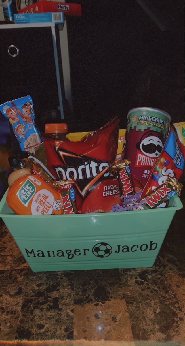 a green container filled with snacks and drinks