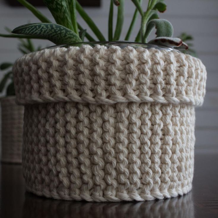 a crocheted planter is sitting on a table