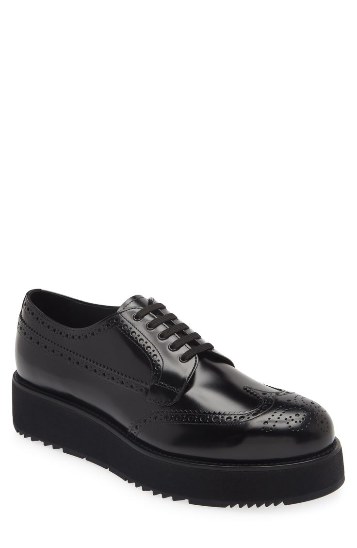 This derby reimagines a timeless style with a modern, single-piece rubber sole, bringing a casualness to the polish of brushed leather and brogue details. Lace-up style Leather upper and lining/rubber sole Made in Italy Designer Shoes Formal Patent Leather Oxfords With Lug Sole, Business Patent Leather Oxfords With Lug Sole, Luxury Oxfords With Lug Sole For Workwear, Patent Leather Oxfords With Lug Sole For Office, Luxury Lug Sole Oxfords For Work, Office Oxfords With Lug Sole In Patent Leather, Luxury Business Oxfords With Lug Sole, Luxury Black Glossy Oxfords, Luxury Black Men's Derby Shoes