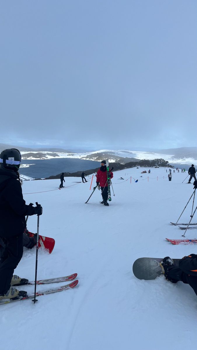 skiers and snowboarders are on the snowy slope