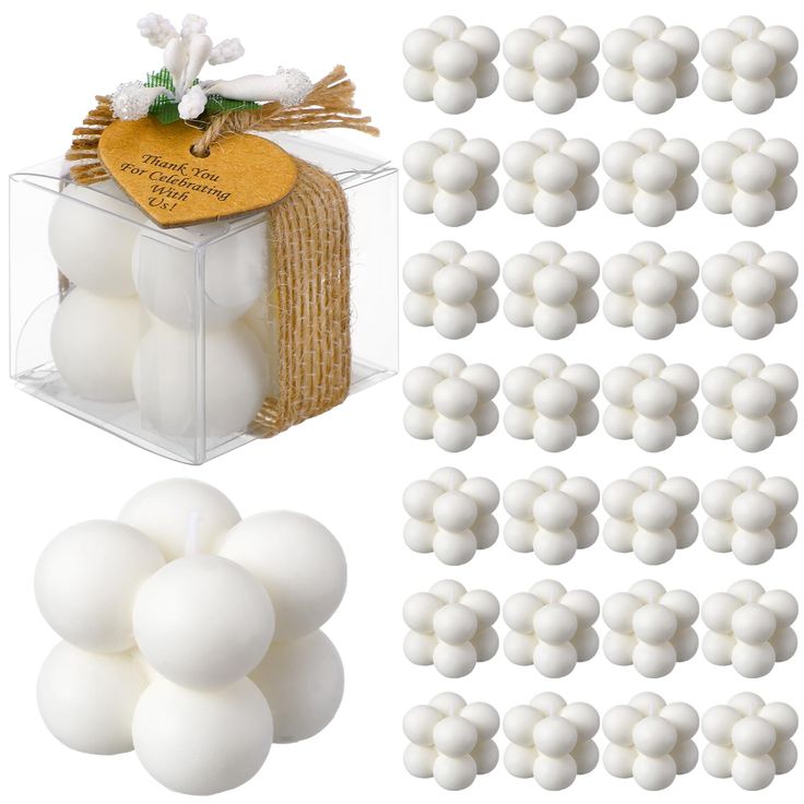 white plastic balls are in a clear box with burlocked tags on them