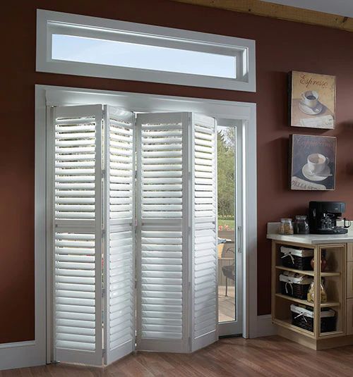 an open door with white shutters in a living room