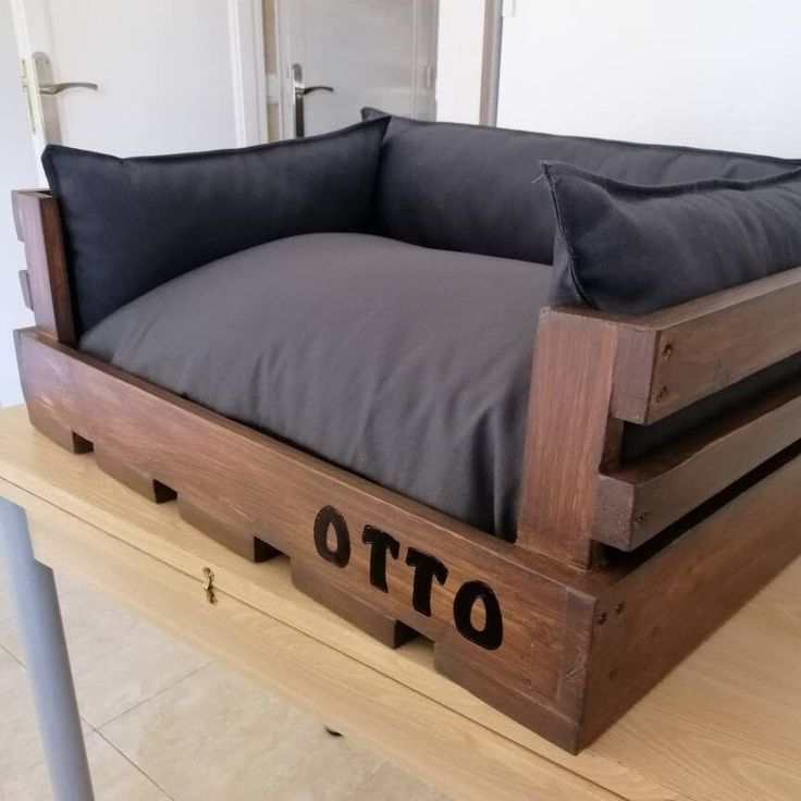 a couch made out of wood and black pillows