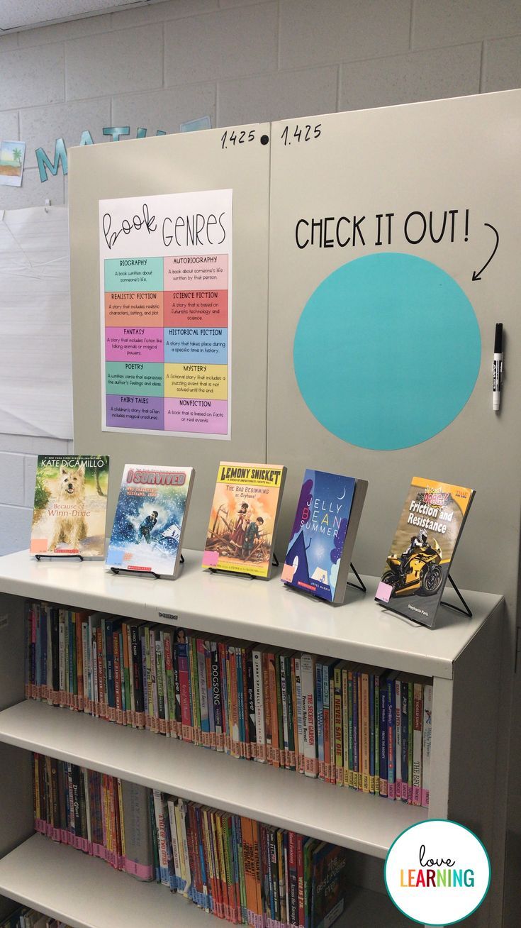 a book display with books on it in front of a whiteboard