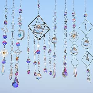 many different types of necklaces hanging from chains on a blue sky background with the sun shining through them