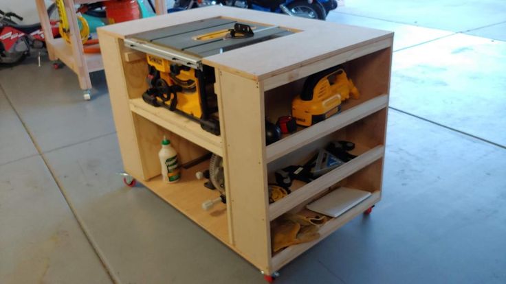 a workbench with tools in it on the floor next to some other items