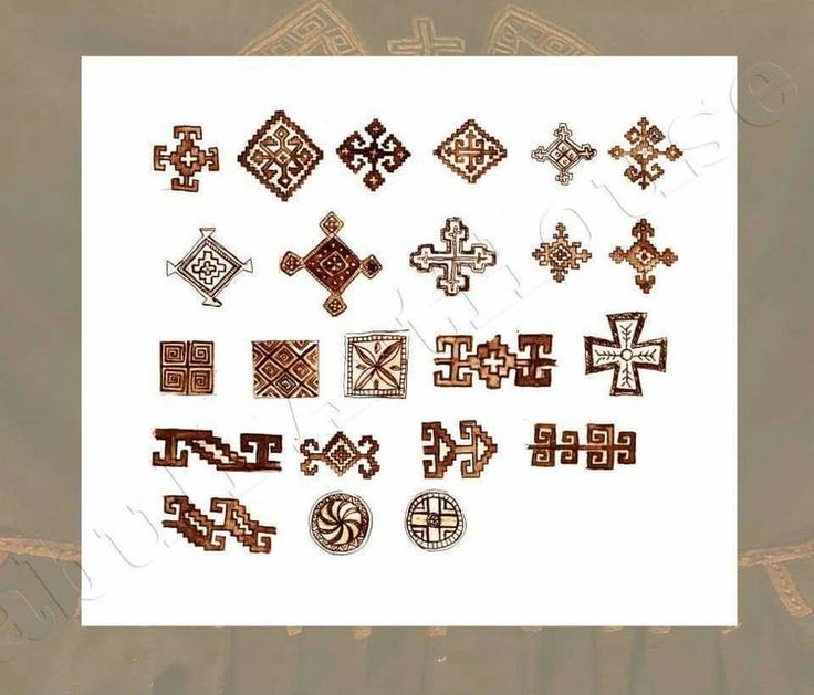 an assortment of decorative wooden crosses on a white background with gold border around the edges