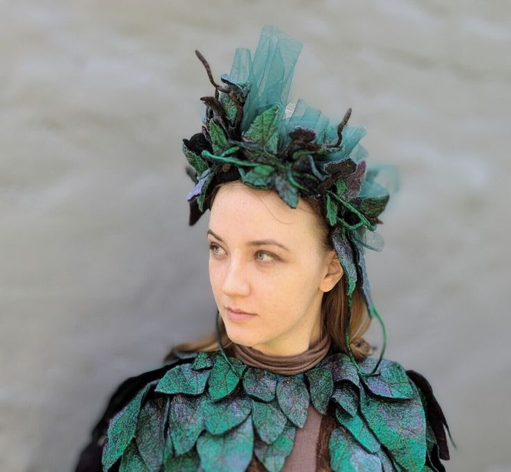 Immerse yourself in the enchanting world of nature with our Leafy Wreath, expertly crafted from soft wool. This unique accessory is perfect for LARP adventures, mystical masquerades, or embodying the mystical spirit of woodland creatures. Each leaf and twig of the wreath is meticulously crafted from wool, preserving their natural texture and vibrant green hue. The wreath exudes elegance, evoking imagery of ancient forests and magical realms. The base of the wreath features a flexible steel hoop, Green Fantasy Cosplay Costume For Fantasy Events, Green Fantasy Style Cosplay Costume, Green Fantasy Cosplay Costume For Costume Party, Green Fantasy Costume For Costume Party, Fairycore Costumes For Costume Party And Cosplay Events, Fairycore Fairy Dress For Halloween Cosplay, Green Fantasy Cosplay Costume, Halloween Fairycore Dress For Cosplay, Halloween Fairycore Fairy Dress Costume