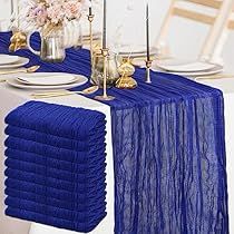 the table is set with blue linens and place settings