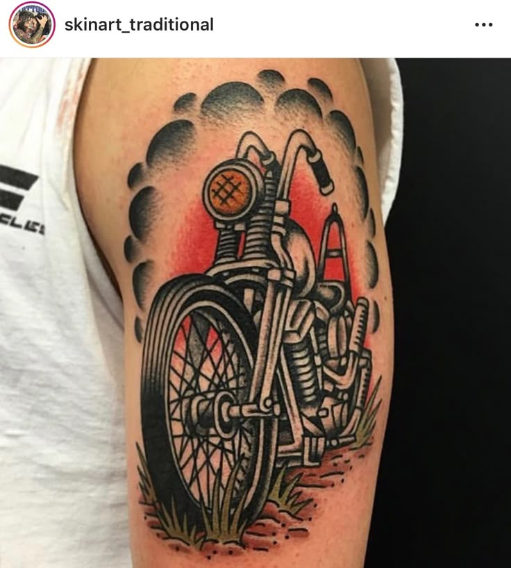 a man with a motorcycle tattoo on his arm