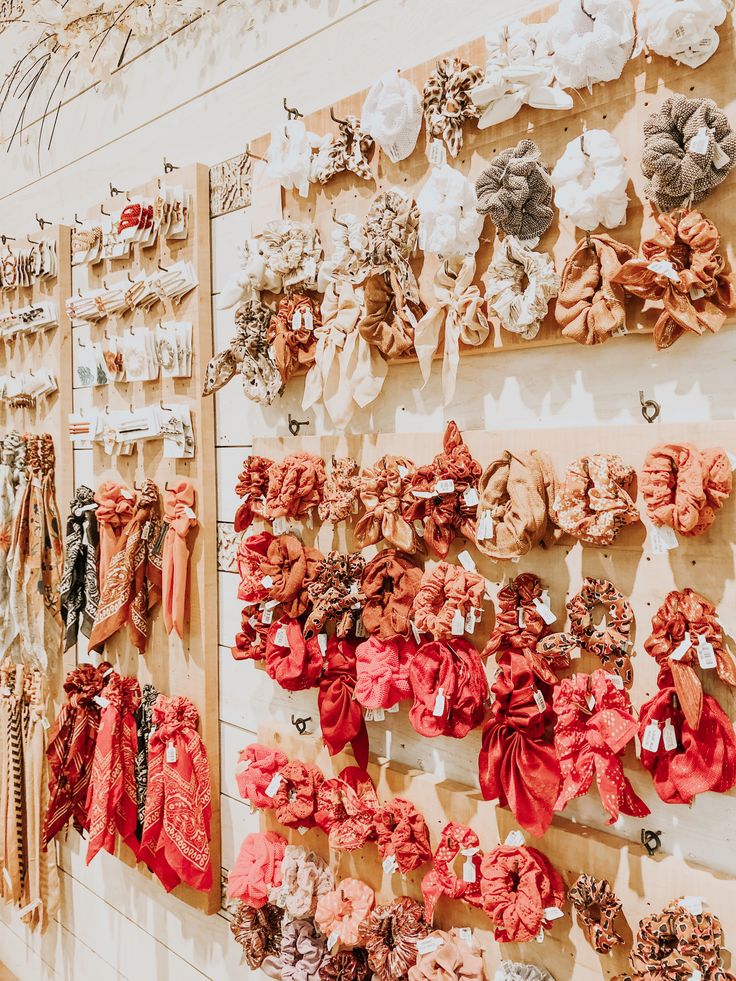 a wall covered in lots of different types of scarves