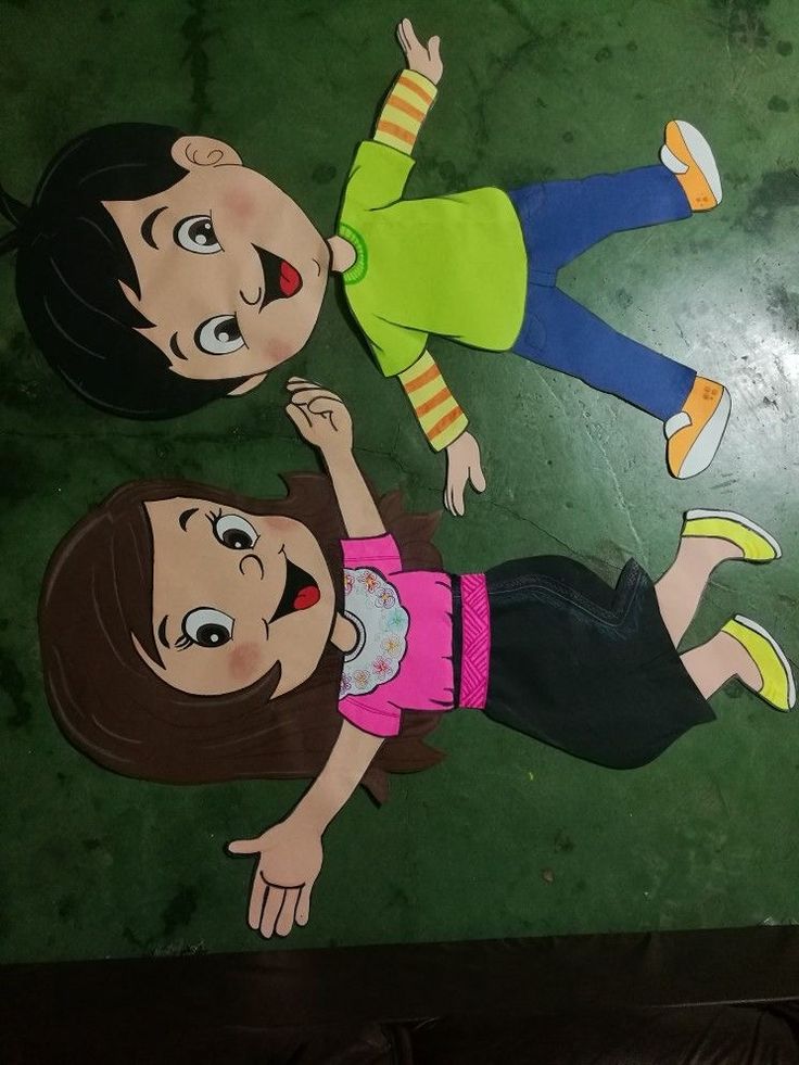 two children standing next to each other in front of a painting on the floor that looks like they are holding hands