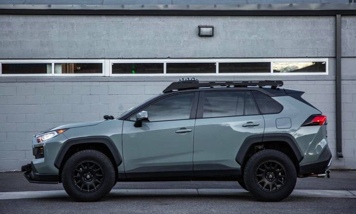 a grey suv parked in front of a building