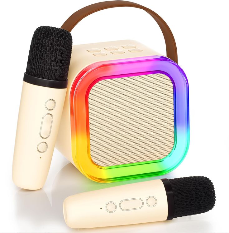 two microphones sitting next to each other on top of a white surface with a rainbow colored speaker in the middle