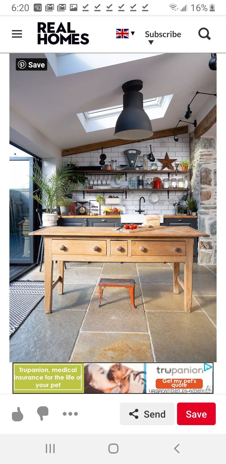 an image of a kitchen with a table in the middle