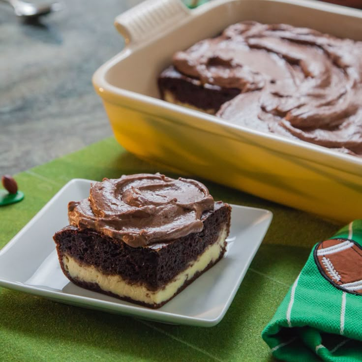 two pieces of cake sitting on top of a white plate next to a green cloth