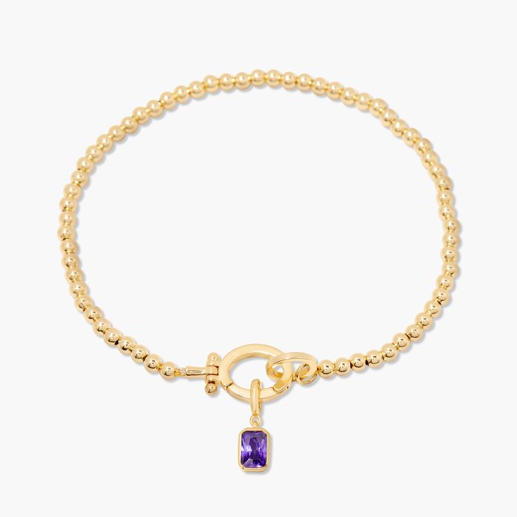 Treat your wrists to some bling with the Mackenzie Birthstone Bracelet. With a vivid birthstone charm, and intricately-beaded gold, this sparkling accessory is sure to add a touch of glam to any outfit. Avery Bracelet: Available in 14k gold plated or rhodium plated brass, 6" bead bracelet, hinge closure measures 1/2", 4mm beads Mackenzie Hinge Birthstone Charm: Available in 14k gold plated sterling silver or rhodium plated sterling silver1/8"x1/4" charm, 5mm Cubic Zirconia NOTE - open bracelet h Elegant Gold Charm Bracelet With Birthstone, Gold Beaded Bracelets With Gemstone Accents, Adjustable Gold Beaded Bracelets With Gemstone Accents, Elegant Gold Crystal Bracelet With Birthstone, Elegant Gold Beaded Bracelets With Gemstone Accents, Elegant Gold Crystal Birthstone Bracelet, Gold Charm Bracelet With Birthstone, Gold Bracelets With Gemstone Accents And Round Beads, Elegant Jeweled Beaded Bracelets For Gift