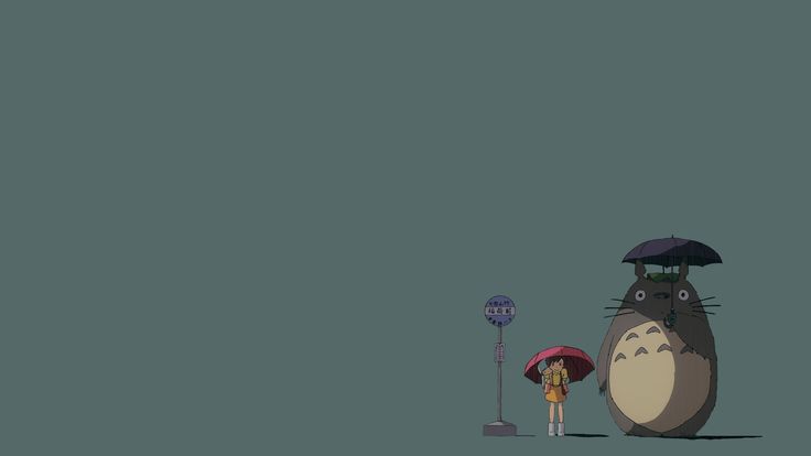 a person holding an umbrella standing in front of a totoro and a street light