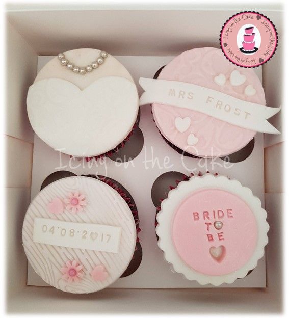 four decorated cupcakes in a box for a bride to be