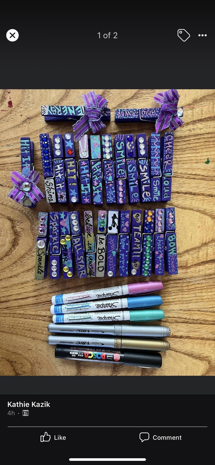 some pens are laying on top of each other and wrapped in purple paper with bows