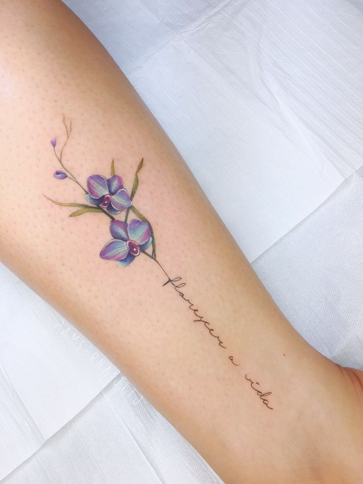 a woman's leg with a flower tattoo on it