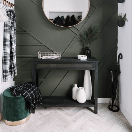 a black and white entryway with green accents