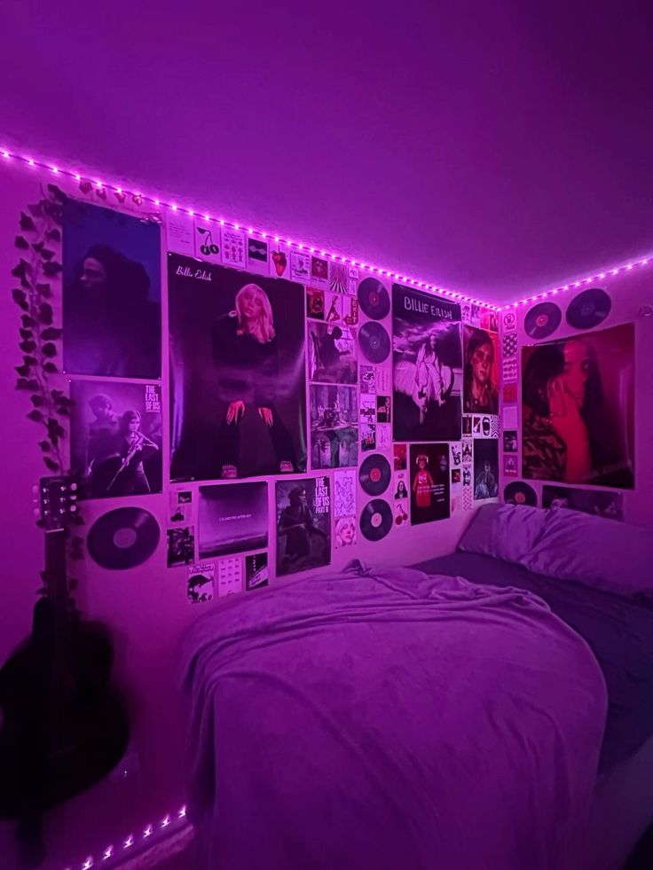 a bedroom with purple lights and pictures on the wall