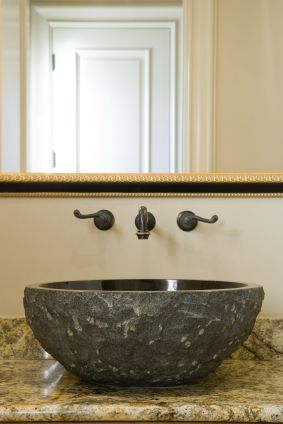 a bathroom sink sitting under a large mirror