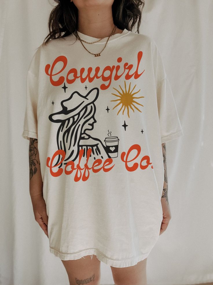 Cowgirl Coffee Co Tee – We The Babes Comfortable Graphic Print T-shirt, Casual Coffee-colored Screen Print T-shirt, Coffee Color Short Sleeve T-shirt With Screen Print, Comfortable Graphic Print T-shirt For Streetwear, Comfortable Cotton T-shirt With Screen Print, Casual Relaxed Fit T-shirt In Ring-spun Cotton, Graphic Print Ring-spun Cotton Top, Summer Coffee Colored Tops With Graphic Print, Soft-washed White Tops In Ring-spun Cotton