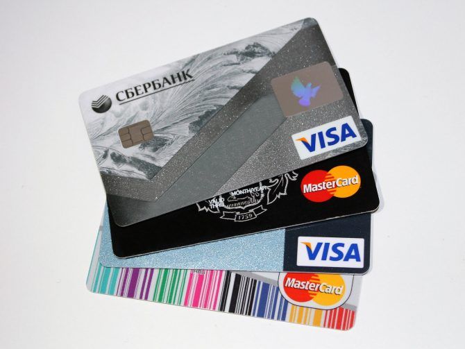 credit cards stacked on top of each other with different colors and designs around them,