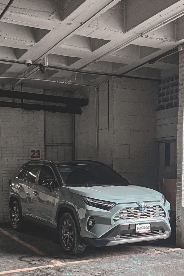 two cars are parked in an empty parking garage