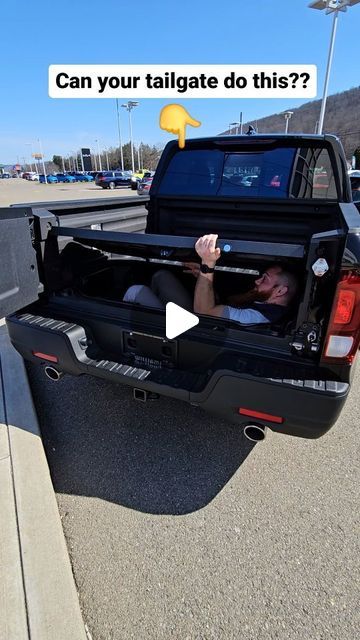 a man is sitting in the back of a truck