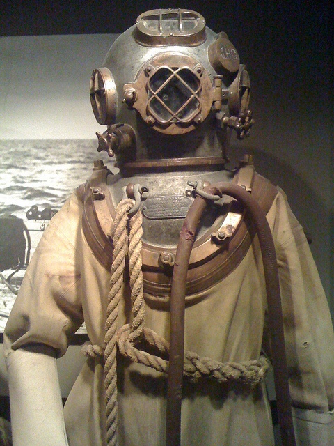 an old diving suit on display in a museum