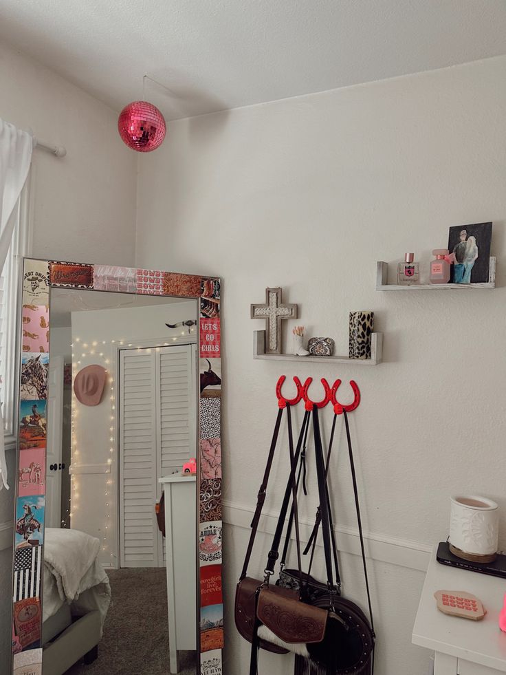 a room with a mirror, coat rack and other items on the wall in front of it