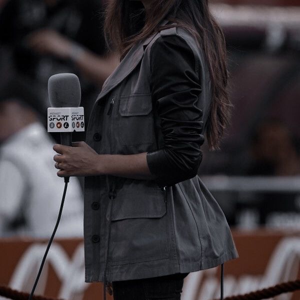 a woman standing in front of a microphone