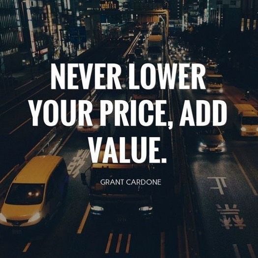 the quote never lower your price, add value by grant cardone on an urban street at night