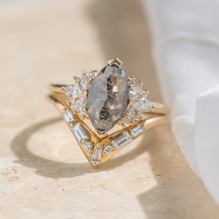 a diamond ring sitting on top of a white cloth