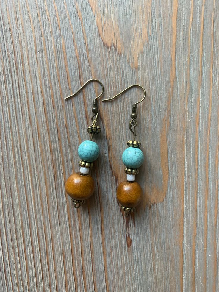 Handcrafted earrings with a rustic and colorful flare! All made to order. Bohemian Multicolor Wooden Bead Earrings, Brown Artsy Earrings, Bohemian Brown Earrings As Gift, Bohemian Brown Earrings For Gift, Handmade Brown Bohemian Earrings, Handmade Bohemian Brown Earrings, Brown Dangle Earrings With Artsy Style, Earthy Brown Earrings For Festivals, Vintage Brown Beaded Earrings As Gift