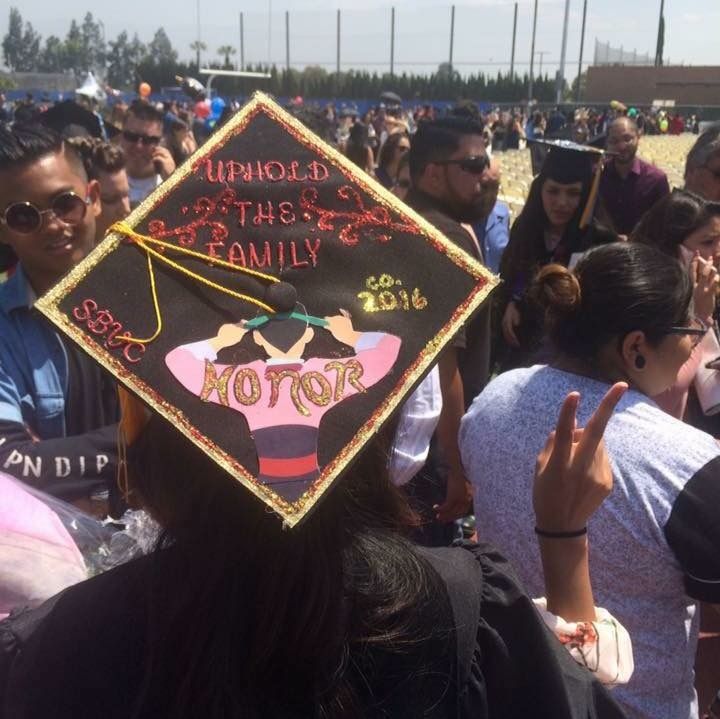 a group of people standing around each other at a graduation ceremony with one person wearing a cap